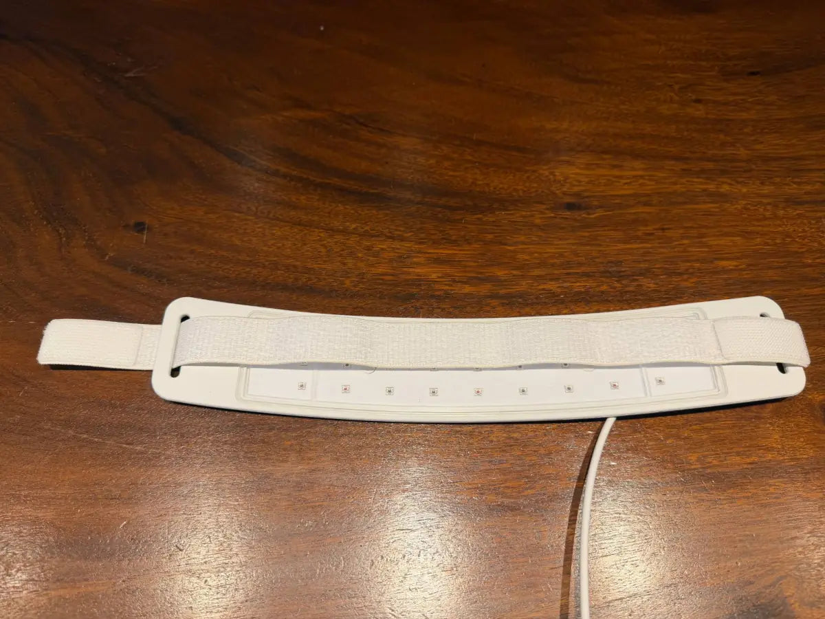 The full collar lying flat with the strap running across it